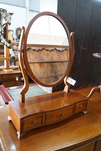 A George III style yew serpentine toilet mirror, height 64cm, together with a Victorian folding towel rail and a mahogany tripod wine table
